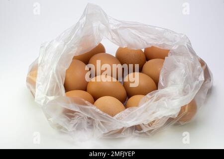 Eggs in a transparent plastic bag on a white isolated background. Stock Photo