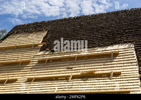 Roof construction site. Removal of old roof, replacement with new shingles, equipment and repair. Roofs are a very important part of all housing proje Stock Photo