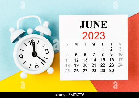 June 2023 Monthly calendar year with alarm clock on colourful background. Stock Photo