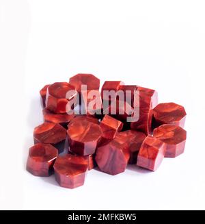 red wax melts on a white background used for various purposes such as decoration, sealing bottles, art and craft projects, invitations and wedding fav Stock Photo
