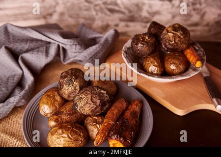 Baked healthy vegetables on rustic background - carrots, potatoes, beetroot. Whole food diet, Mediterranean diet Stock Photo