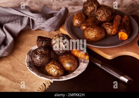 Baked healthy vegetables on rustic background - carrots, potatoes, beetroot. Whole food diet, Mediterranean diet Stock Photo
