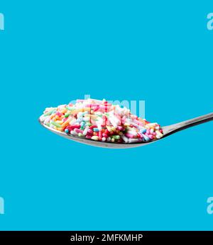 Photo of a spoon with confectionery sprinkles. Full depth of field. Clipping path Stock Photo