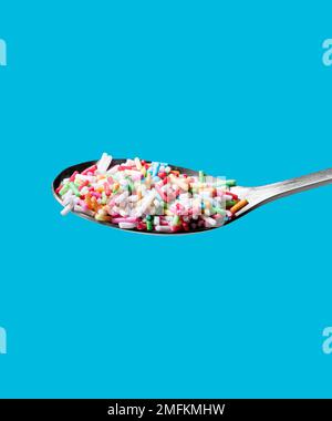 Photo of a spoon with confectionery sprinkles. Full depth of field. Clipping path Stock Photo