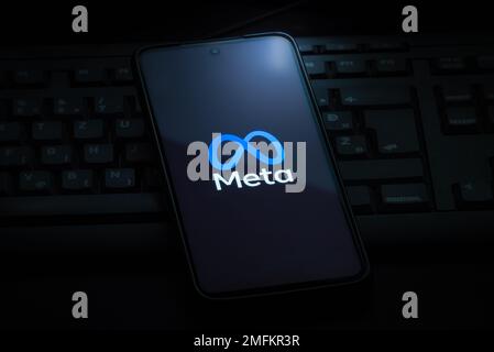 Ljubljana, Slovenia - 21 January 2023: Meta logo on smartphone screen laying on computer keyboard Stock Photo