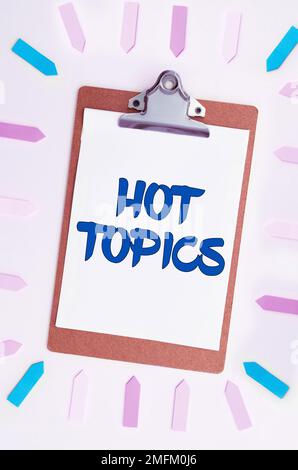 Writing displaying text Hot Topics. Business concept subject that a lot of people are arguing and discussing Stock Photo