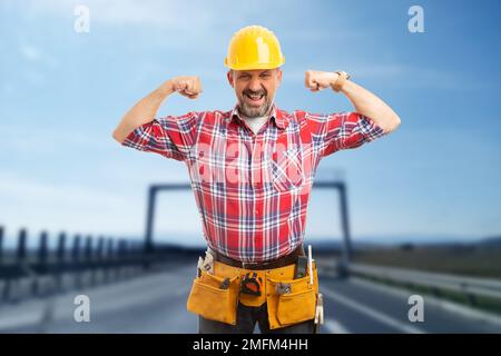 Positive worker making tension gesture with hands as success concept on freeway Stock Photo