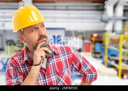 Male making thinking gesture with hand on chin and holding ruler as finding solution concept Stock Photo
