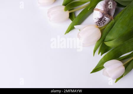 Festive composition with tulips and quail eggs. Easter background Stock Photo