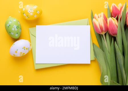 Template for Easter greeting card. Blank card with an envelope and bouquet of tulips Stock Photo