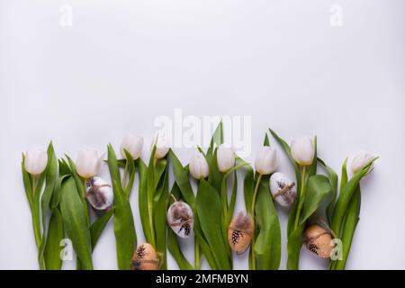 Festive composition with tulips and quail eggs. Easter background Stock Photo