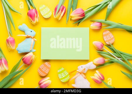 Template for Easter greeting card. Easter festive frame with eggs, tulips and easter bunny Stock Photo