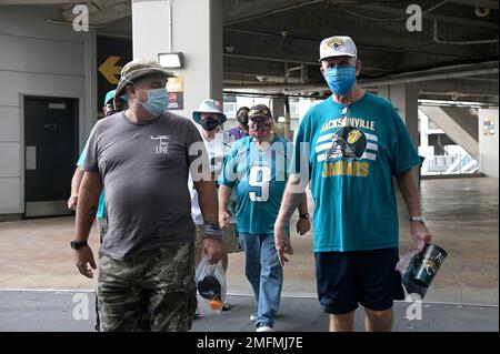 Fans wear masks while walking in the gift shop before a baseball