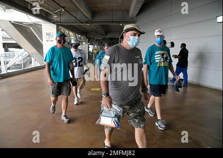 Fans wear masks while walking in the gift shop before a baseball