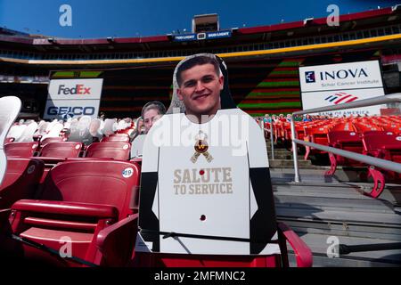 Salute to Service tributes are seen on fan cut-outs in seating areas of  FedEx Field before the start of an NFL football game between the New York  Giants and Washington Football Team,