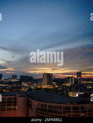 Blurry Panoramic view of city skyline, traffic and light during sunset. Colourful city lights. Stock Photo