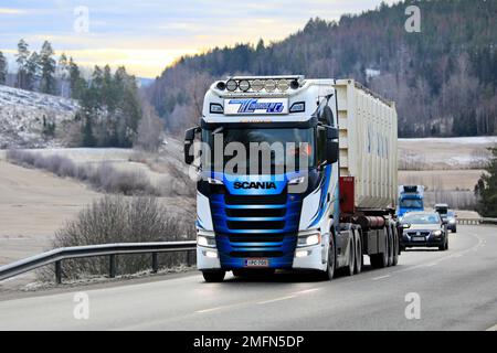 Customised Scania truck of Transport K. Lindholm & Co transports container along highway on a day of winter. Salo, Finland. January 20, 2022. Stock Photo