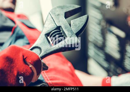 Industrial Worker with Large Adjustable Wrench in His Hand Preparing For a Big Job. Stock Photo