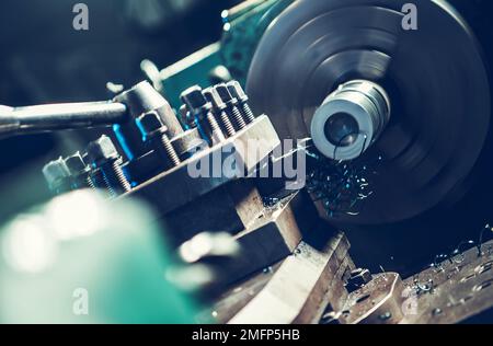 Spinning Lathe Machine Metal Piece Processing Close Up Photo. Metalworking Industry Theme. Stock Photo