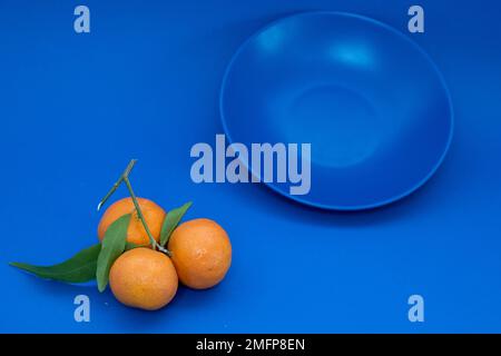 Fresh tangerines on a blue background  Stock Photo