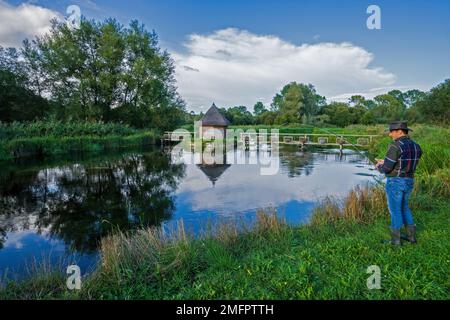 Fisherman's hut and eel traps across the River Test on the Leckford Estate at Longstock. Hampshire. England. UK Stock Photo