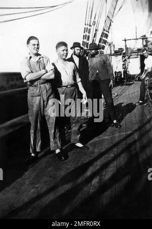 Five sailors standing on the deck of the four-masted steel barque Hougomont, circa 1928. Stock Photo