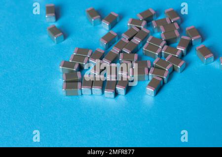 smd ceramic capacitors, on a blue table, electronic components Stock Photo