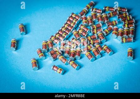 SMD diodes, on a table with a blue background, electronic components Stock Photo