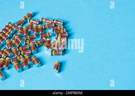 SMD diodes, on a table with a blue background, electronic components Stock Photo