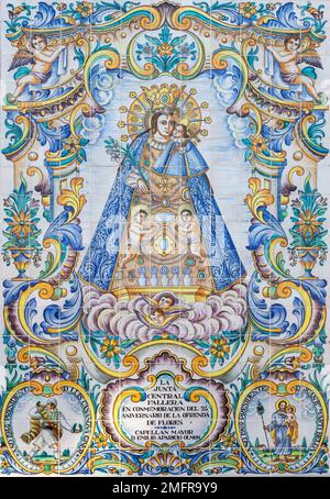 VALENCIA, SPAIN - FEBRUAR 17, 2022: The ceramic tiled Madonna on the facade of church Basilica de la Mare de Deu dels Desamparats by J. Gimeno 20.cent. Stock Photo