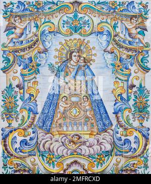 VALENCIA, SPAIN - FEBRUAR 17, 2022: The ceramic tiled Madonna on the facade of church Basilica de la Mare de Deu dels Desamparats by J. Gimeno 20.cent Stock Photo