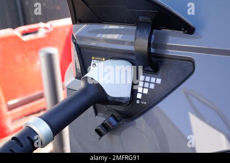 Power cable pump plug in charging vehicle to electric EV car with modern technology Stock Photo