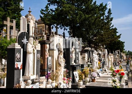 Artistic graves and sculptures in the cemetery Cimitero monumentale di Paternò, located on the slopes of Mount Etna, Mongibello. Stock Photo