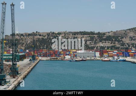 View on basin with green cargo cranes used for scrap situated in the port ready for loading on the ships. Stock Photo