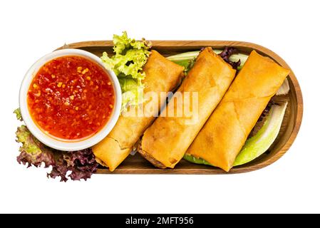 Top view of homemade Deep Fried Spring Roll with Chili Sauce and vegetable in wooden tray on white background with clipping path Stock Photo