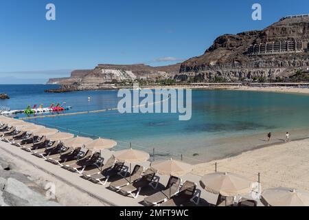 AMADORES, GRAN CANARIA, CANARY ISLANDS, SPAIN - MARCH 6 : View of the beach at Amadores, Gran Canaria on March 6, 2022. Two unidentified people Stock Photo