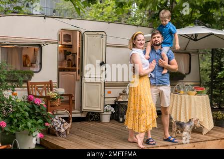 long shot family posing their caravan Stock Photo