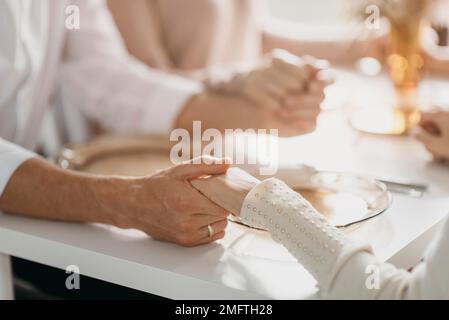 beautiful family praying before eating close up Stock Photo