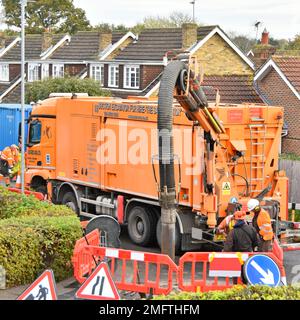 Workmen use suction excavator by German business RSP on hgv Mercedes lorry truck quickly creating single earth pit to expose underground gas main UK Stock Photo