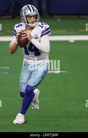 Landover, United States. 25th Oct, 2020. Dallas Cowboys quarterback Andy  Dalton (14) evades Washington Football Team linebacker Cole Holcomb (55)  during the first half of an NFL football game at FedEx Field