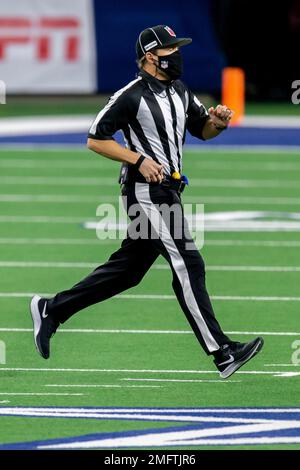 Line judge Walt Coleman IV (65) runs across the field during an NFL  football game between the Arizona Cardinals and Dallas Cowboys, Monday,  Oct. 19, 2020, in Arlington, Texas. Coleman also wears