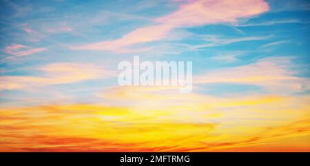 Sunset with sun and clouds on blue and orange dramatic sky with sun rays Stock Photo