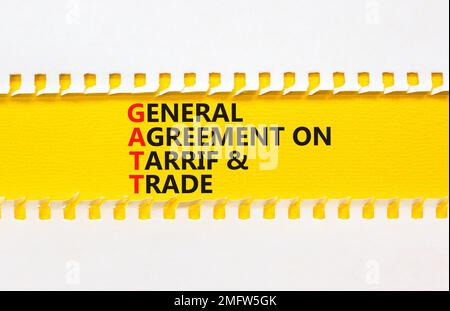 GATT symbol. Concept words GATT general agreement on tariff and trade on yellow paper on beautiful white background. Business GATT general agreement o Stock Photo