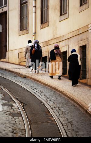 Muslim women walk the streets of Lisbon Stock Photo