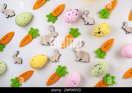 Easter pattern easter pattern eggs rabbit carrot Easter pattern made of colored eggs, decorative carrots and bunny rabbits on light background. Minimal festive spring concept.made of colored eggs, decorative carrots, and yellow bunny rabbits on pastel blue background. Minimal festive spring concept. Stock Photo