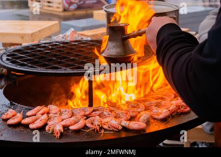 Process of grilling red king prawns and preparing Turkish coffee on brazier Stock Photo