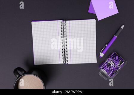 Coffee Cup Standing on Desk. Important infrormation written on paper. Different Office Supplies, Pencils, Pens, Marckers. Computer keyboard. Text on Stock Photo