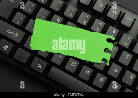 Colored sticker lying on keyboard. Important message written over paper. Stock Photo