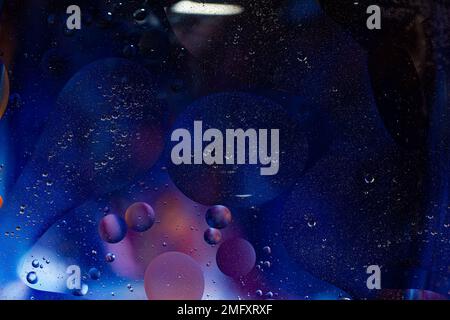 Photo of oil on a water surface with bubbles. Abstract colorful background. Macro close-up, not illustration . Stock Photo