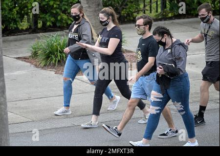 Fans wear masks while walking in the gift shop before a baseball